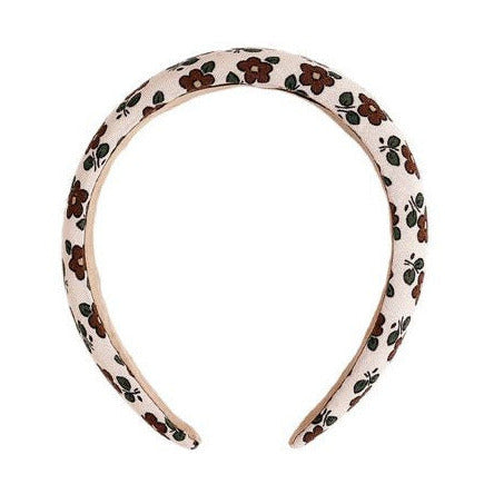 Add style to your outfit with the Rylee & Cru Padded Headband, featuring a white base adorned with brown flowers and green leaves.