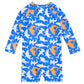 The Snapper Rock Baby Boys' Shark Squad LS Sunsuit features a blue long-sleeve one-piece with an orange and white shark pattern and UPF50+ protection, shown from the back for safe, fun days in the sun.