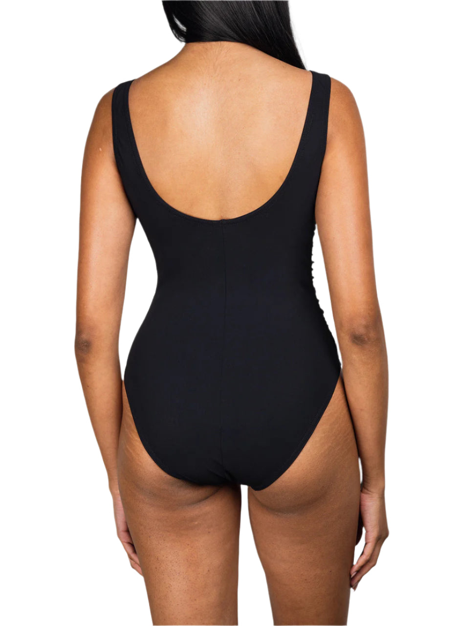 A person is shown from the back wearing the Karla Colletto Basics V-Neck Tank with High Back One Piece swimsuit in black, set against a white background.