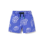 Pepita & Me Baby Boys' and Boys' Playa Azul Swim Trunks in blue with white seashell and starfish pattern, black drawstring with green tips, made from quick-dry fabric, shown on a white background.