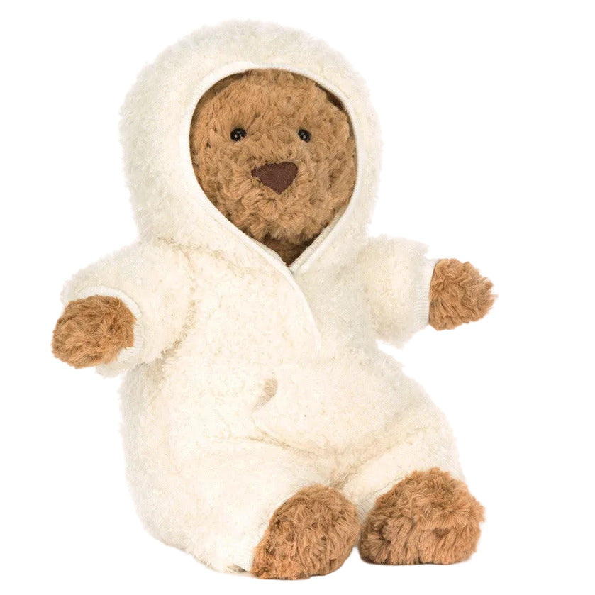 A Jellycat Bartholomew Bear All-in-One Outfit, in cozy white and classic brown, sits upright facing slightly to the side—ideal for relaxing during hibernation season against a simple background.