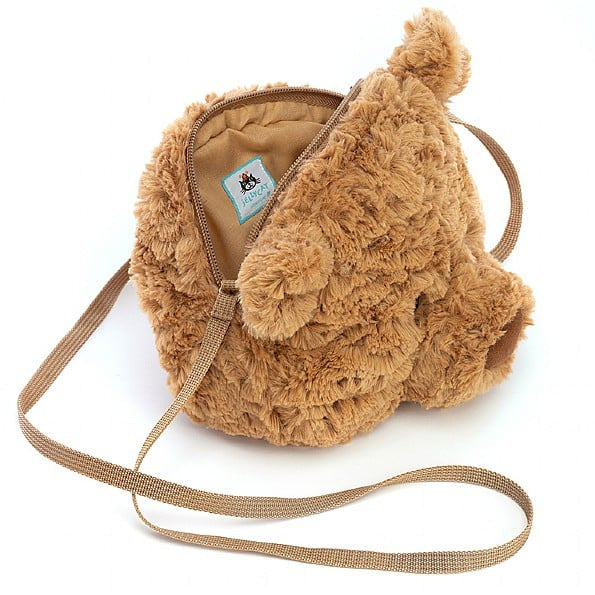 The Jellycat Bartholomew Bear Bag is a small, plush brown cross-body bag with a zipper opening, inner lining, and fabric tag.
