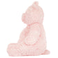 A side view of Leola Bear Large by Jellycat, in pink and fluffy fur, sitting upright against a plain white background.
