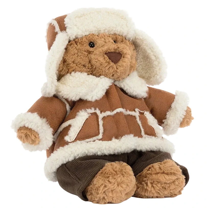 Jellycat Bartholomew Bear ‘Alpine’ wearing a faux shearling-lined coat and matching trapper hat for winter couture.
