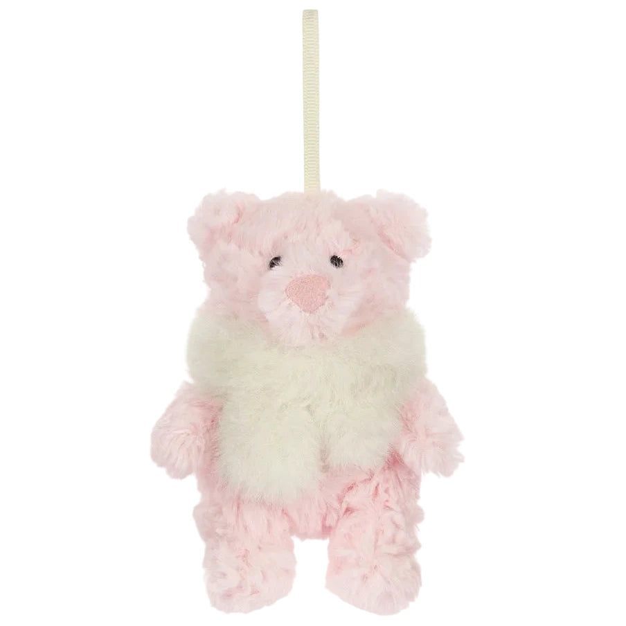 A small, pale pink Jellycat Leola Bear Winter Warmer Decoration ornament wearing a fuzzy white scarf and hanging from a ribbon.