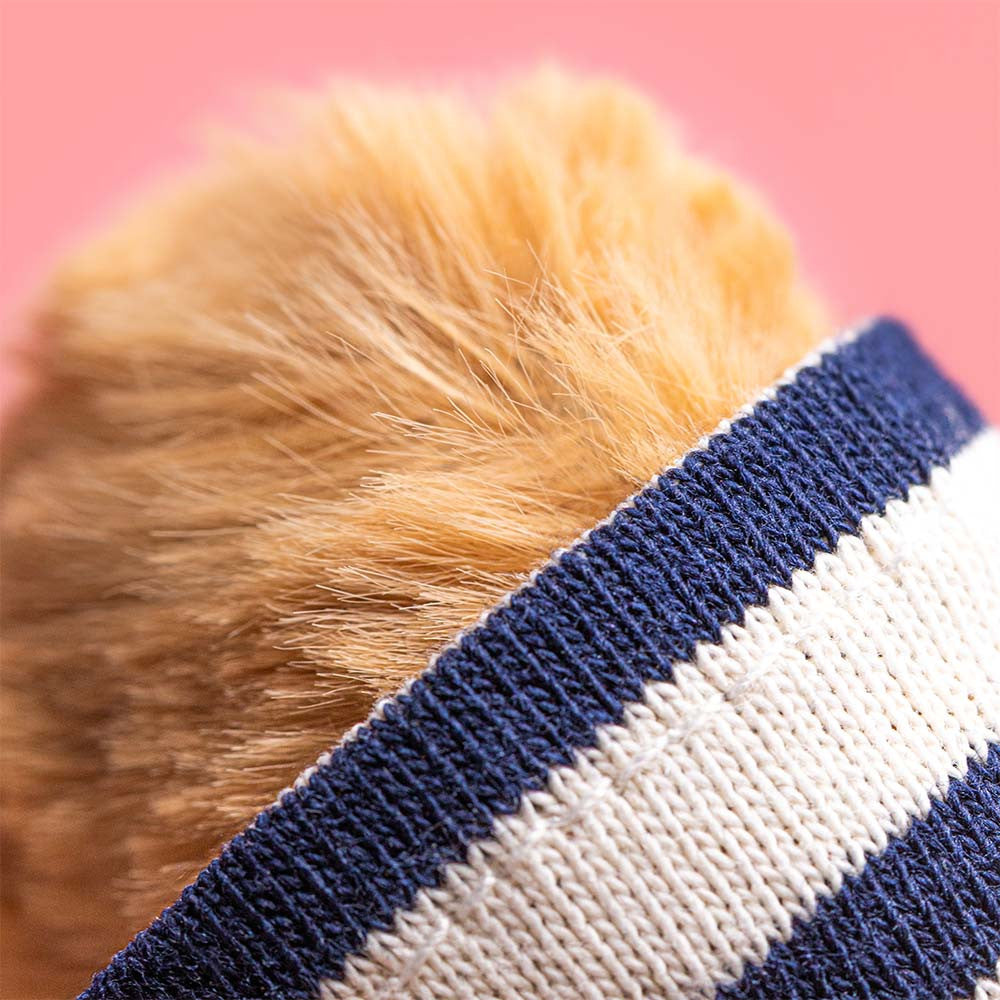 Close-up of Jellycat Bartholomew Bear in his Seafarer Outfit, featuring a blue and white striped headband, set against a pink background.