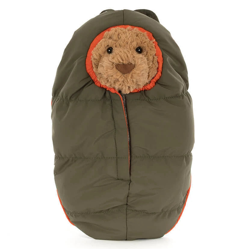 A Bartholomew Bear face peeks out from the hood of Jellycat's olive green, puffy Bartholomew Bear Hiking Outfit baby bunting with orange trim.