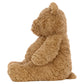 Side view of Jellycat’s Bartholomew Bear, Medium—a brown teddy with a fluffy fudge tummy—sitting upright against a plain white background, making it the perfect bedtime buddy.
