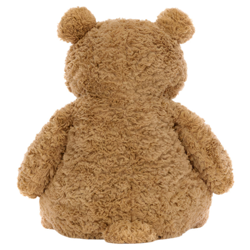 The Jellycat Bartholomew Bear, Medium, sits with its back to the camera, highlighting its cuddly fudge-colored tummy against a white background.