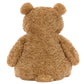 The Jellycat Bartholomew Bear Huge, a brown, fluffy teddy bear, is pictured sitting with its back to the viewer, showing off its round ears and short tail.