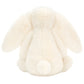 The Jellycat Bashful Bunny Cream Medium plush is shown from the back, its floppy ears and round tail evoking the sweet charm of a soft bunny companion.