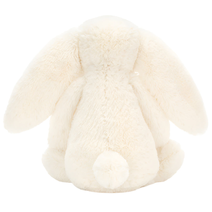 The Jellycat Bashful Bunny Cream Medium plush is shown from the back, its floppy ears and round tail evoking the sweet charm of a soft bunny companion.