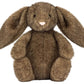 The Jellycat Hoppleston Luxe Bunny Original is a brown plush bunny with long floppy ears, round black eyes, and a pink nose, shown sitting upright on a white background.