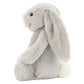 The Bashful Silver Bunny by Jellycat is a soft plush in a gentle silver shade, featuring long floppy ears, a pink nose, black eyes, and a white tail—perfect as a bedtime story companion.