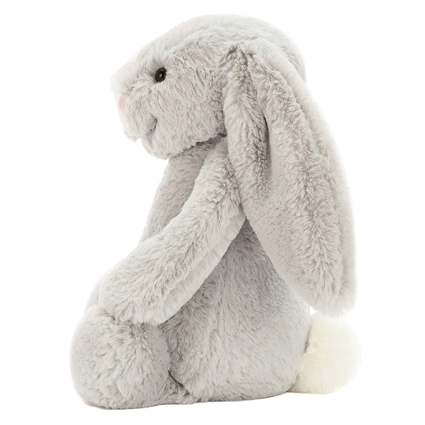 The Bashful Silver Bunny by Jellycat is a soft plush in a gentle silver shade, featuring long floppy ears, a pink nose, black eyes, and a white tail—perfect as a bedtime story companion.