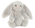 The Jellycat Bashful Silver Bunny is a soft plush with floppy ears, black button eyes, and a pink nose, shown sitting upright against a plain white background—ideal for bedtime cuddles.