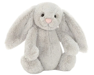The Jellycat Bashful Silver Bunny is a soft plush with floppy ears, black button eyes, and a pink nose, shown sitting upright against a plain white background—ideal for bedtime cuddles.
