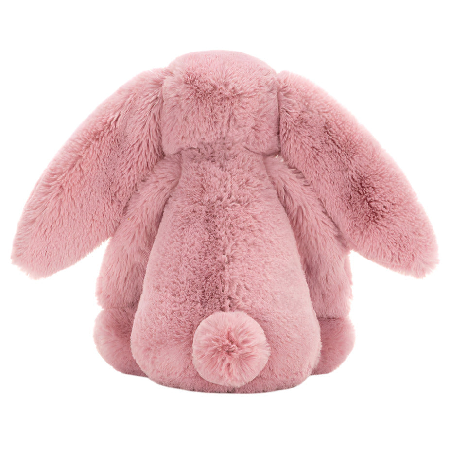 Back view of a pink Jellycat Bashful Tulip Pink Bunny plush toy with long ears and a fluffy tail.