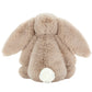 The Jellycat Bashful Bunny Beige Medium is a soft plush toy with floppy ears and a white tail, sitting sweetly with its back to the camera.