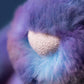 Close-up of the Jellycat Zodihop Luxe Bunny, highlighting its soft, fluffy purple and blue fur with cosmic patterns and a beige textured nose.