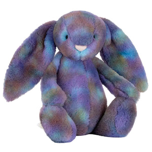 The Jellycat Zodihop Luxe Bunny plush toy features long floppy ears, ultra-soft fur with a cosmic pattern in mottled purple, blue, and green shades, and sits upright.
