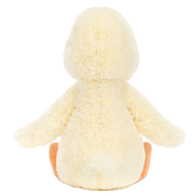 The Jellycat Bashful Duckling plush toy is pictured from behind, displaying its outstretched wings and bright orange feet.