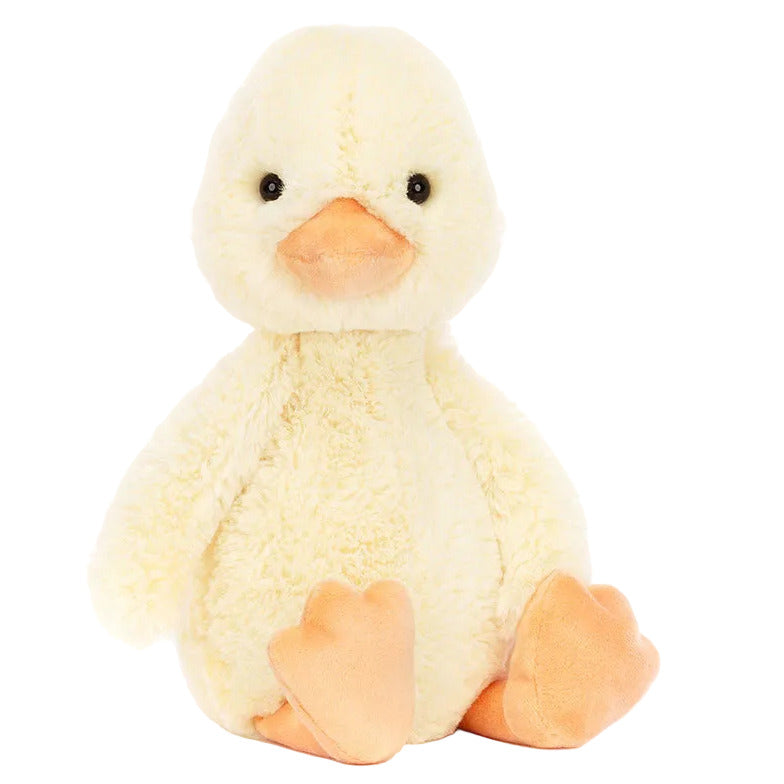 The Jellycat Bashful Duckling plush toy, featuring a yellow body with orange beak and feet, sits upright against a plain white background.