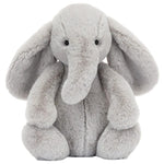 A gray Bashful Luxe Elephant Thuddeus plush by Jellycat with big ears and a long trunk, sitting upright and facing forward.