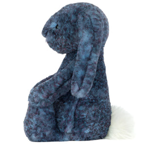 The Jellycat Hopscone Luxe Bunny is a plush blue bunny with floppy ears and a white tail, sitting upright and facing left against a white background.
