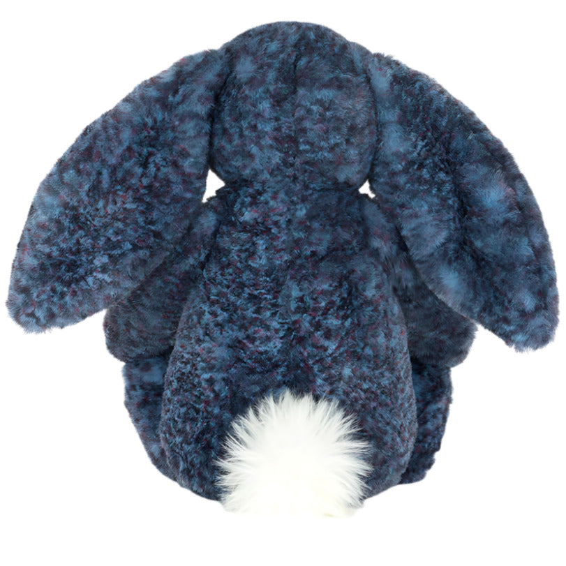 The Jellycat Hopscone Luxe Bunny is a plush toy with dark blue fur, floppy ears, a white fluffy tail, and is shown from the back.