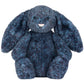 The Jellycat Hopscone Luxe Bunny is a plush dark blue toy with long floppy ears, round black eyes, and a small pink nose, sitting upright on a white background.