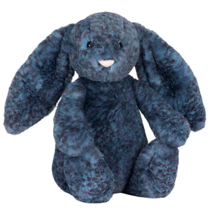The Jellycat Hopscone Luxe Bunny plush features long floppy ears and soft dark blue fur, sitting upright against a white background.