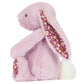 The Thistlepop Blossom Luxe Bunny Original by Jellycat is a plush pink bunny with floral-patterned ears and feet, sitting upright with a fluffy white tail—ideal for pairing with a Rainbow Birthday Cake.