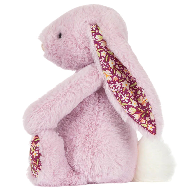 The Thistlepop Blossom Luxe Bunny Original by Jellycat is a plush pink bunny with floral-patterned ears and feet, sitting upright with a fluffy white tail—ideal for pairing with a Rainbow Birthday Cake.