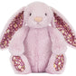 Jellycat's Thistlepop Blossom Luxe Bunny Original is a light pink plush bunny with long floral-patterned ears and matching paw pads, sitting upright against a white background. Part of the adorable Amuseable collection.
