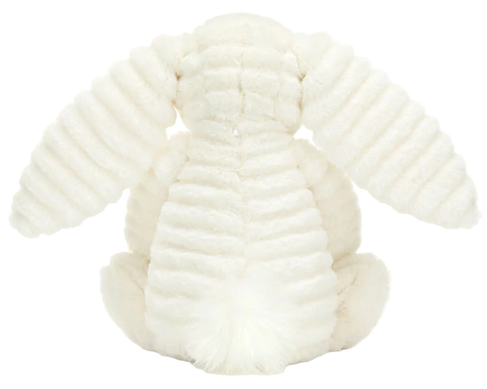 The Jellycat Bashful Luxe Bunny Nimbus plush toy features long floppy ears, a soft ribbed texture, and a fluffy tail, shown from the back in white.