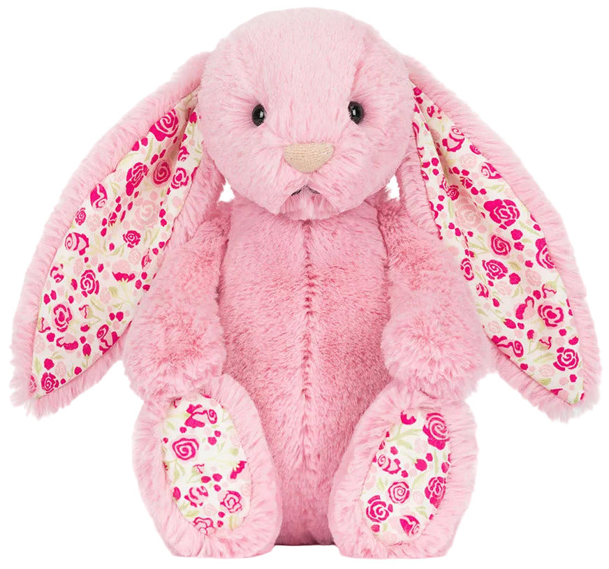 The Jellycat Blushkin Blossom Luxe Bunny Original is a pink plush bunny with long floppy ears lined in a pink floral pattern, sitting upright and facing forward.