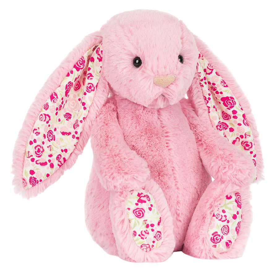 The Jellycat Blushkin Blossom Luxe Bunny Original plush features long floral-patterned ears, matching feet, and a soft pink body, sitting upright.