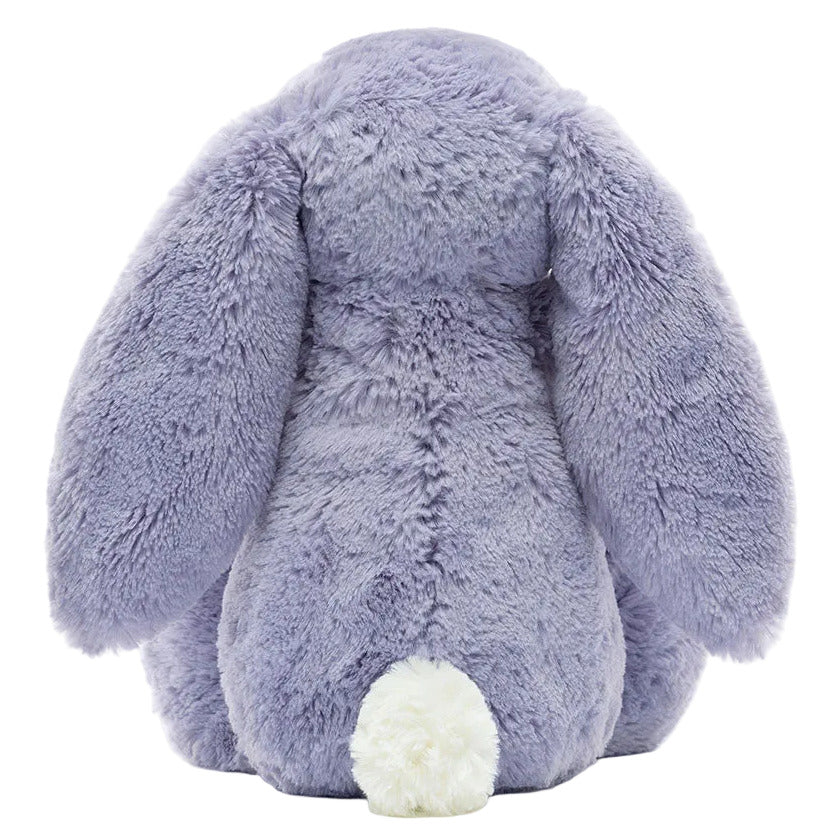The Bashful Viola Bunny by Jellycat is a plush toy in lavender, shown from the back with long floppy ears and a round white tail.