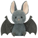 Meet the Jellycat Broox Bat—a plush toy featuring gray fur, large beige inner ears, black eyes, and outstretched black wings. Sitting upright against a white background, this adorable Broox Bat from Jellycat is perfect for snuggles and sparking imaginative adventures.