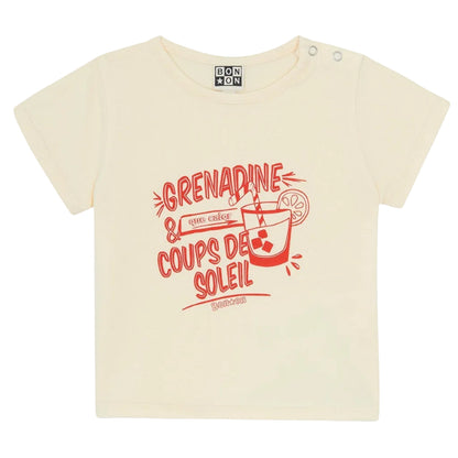The Bonton Baby Tuba Grenadine T-Shirt is a beige, short-sleeve cotton tee featuring red text and a drink graphic with ice, straw, and lemon slice. Part of the Viva la Vida collection, it reads "Grenadine & Coups de Soleil.