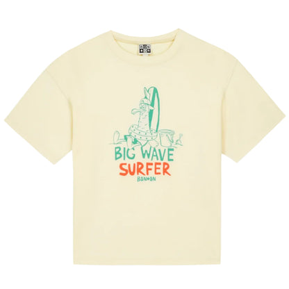 The Boys' Big Wave Livo T-Shirt by Bonton is a pale yellow kids’ summer tee with a cartoon dog and surfboard plus “Big Wave Surfer Bonbon” in green and orange—perfect for playful summer fun.