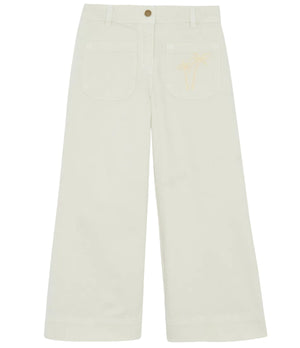 The Bonton Girls' Lakiko Pant features a wide-leg, high-waisted cream design with front patch pockets and a subtle palm tree embroidery on the left pocket.