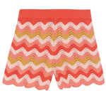 The Bonton Girls' Nine Short features a wavy chevron pattern in coral, pink, yellow, and red with a scalloped hem. Made from 100% cotton for comfort and style.