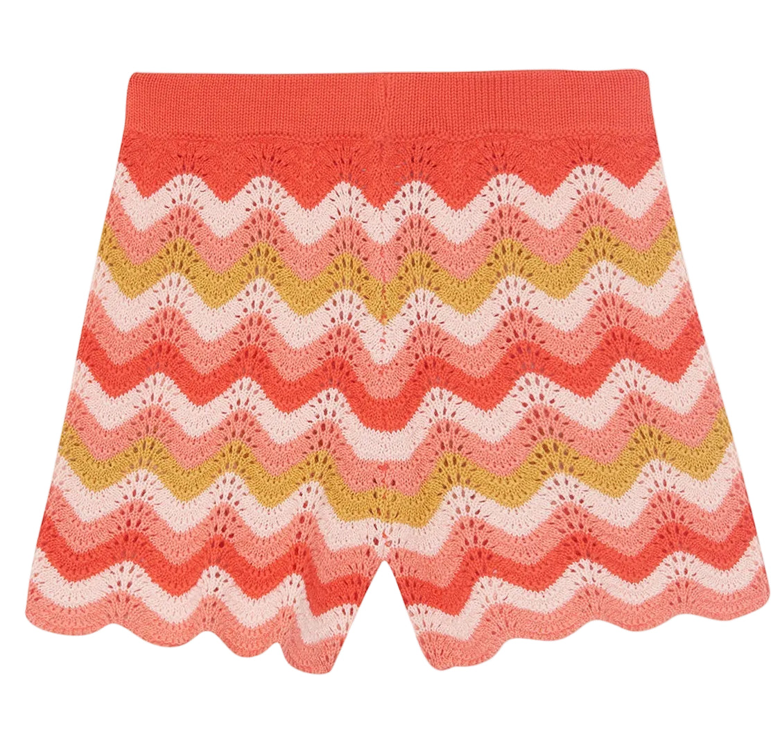 The Bonton Girls' Nine Short features a herringbone pattern in coral, pink, white, and yellow with a scalloped hem and elastic waistband. Made from 100% cotton for comfort and style.