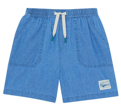 The Bonton Boys' Naples Short features light blue chambray, an elastic waistband with a white drawstring, two front pockets, and a sewn patch label—perfect for kids’ summer play.