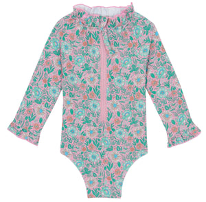 The Bonton Baby Girls' Combinette Swimsuit features long sleeves, a ruffled collar with cuffs, a pink and green floral print, front zipper, and built-in UV protection for safe, stylish sun play.