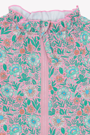 Close-up of Bonton Baby Girls' Combinette Swimsuit featuring a pink base, colorful teal, white, and orange floral pattern, and a vertical center zipper.