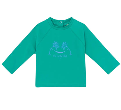 The Bonton Baby Rashguard is a green long-sleeve kids’ shirt with a round neck and front palm tree graphic—ideal as beachwear or a swim t-shirt for fun, sun-filled days.
