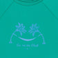 The Bonton Baby Rashguard is a turquoise long-sleeved swim t-shirt for kids, featuring two palm trees with a hammock and "La siesta Club" printed below in light purple.